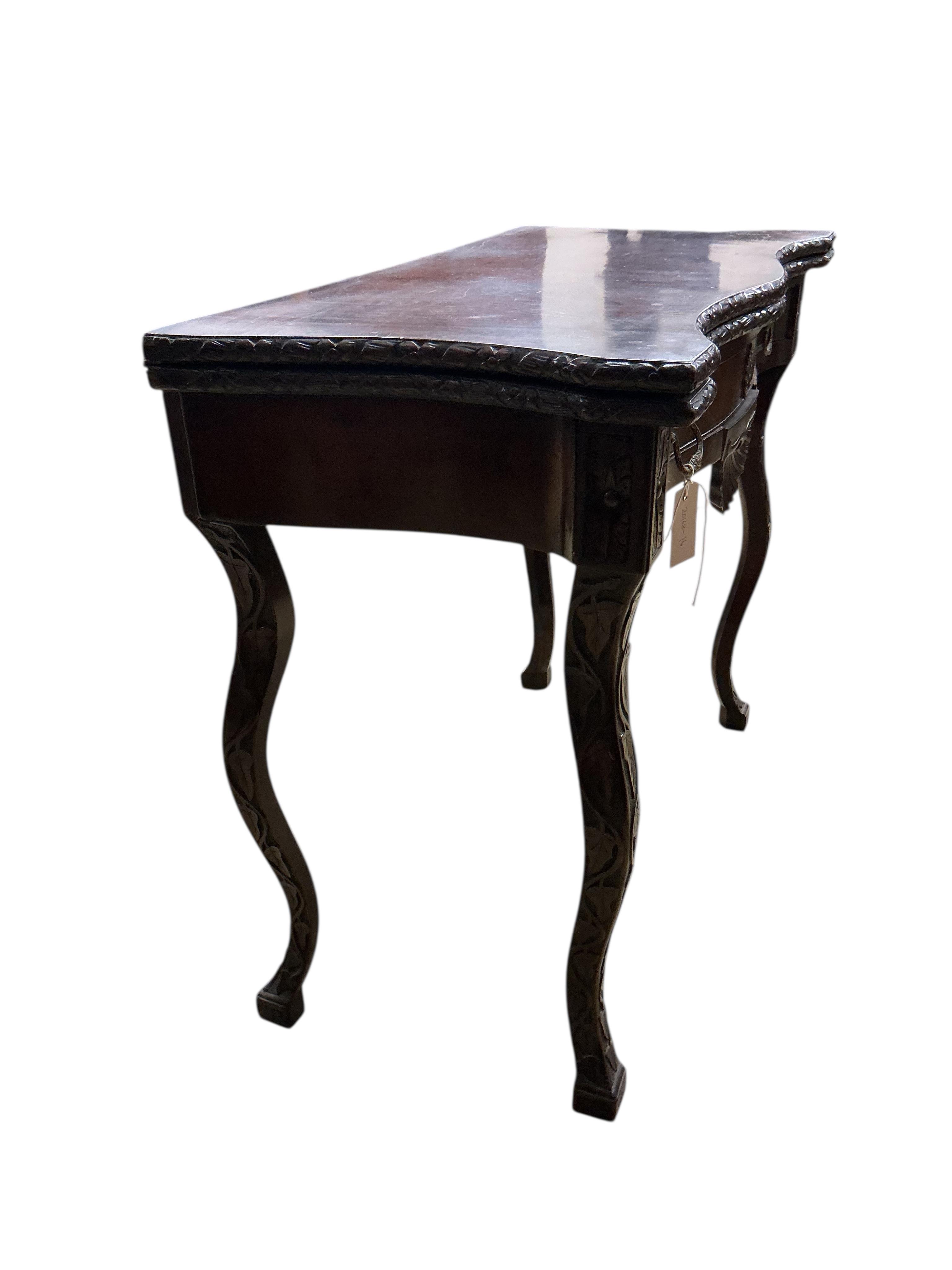 A George II style serpentine mahogany folding card table, width 86cm, depth 43cm, height 73cm